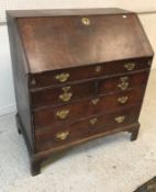 An 18th Century oak bureau, the plain to