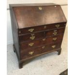 An 18th Century oak bureau, the plain to