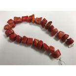 A rough cut red or pink dyed coral secti