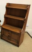 An Ercol elm side cabinet with two open