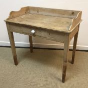 A Victorian pine single drawer washstand with three quarter galleried top, on square tapered legs,