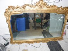 A modern gilt framed mirror in the 19th Century manner with scrolling and acanthus decoration,