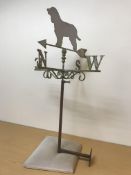 A cast and wrought iron weather vane with spaniel finial, together with a large copper watering can,