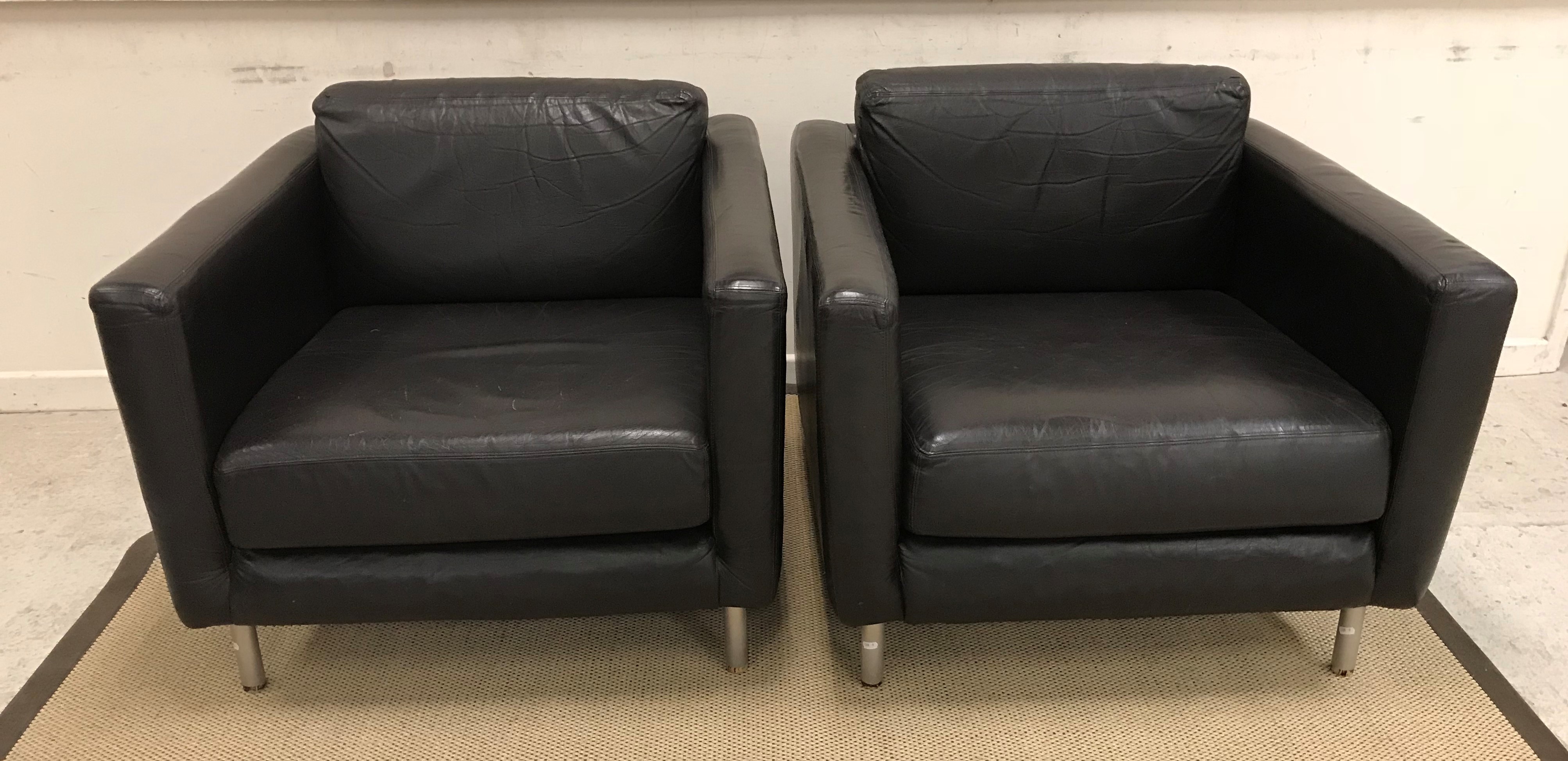 A pair of leather armchairs on tubular chrome supports, probably Habitat,