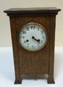 A circa 1900 oak cased mantel clock in the Art Nouveau style,