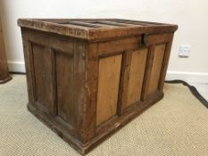 A vintage pine trunk with panelled top and sides, raised on a plinth base, 78.5 cm wide x 49.