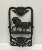 A modern cast iron stable window with horse decoration