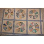 An early 20th Century patchwork quilt of panels of circular discs