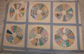 An early 20th Century patchwork quilt of panels of circular discs