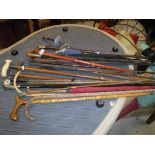 A collection of walking sticks to include a Victorian malacca cane ivory handled stick with silver