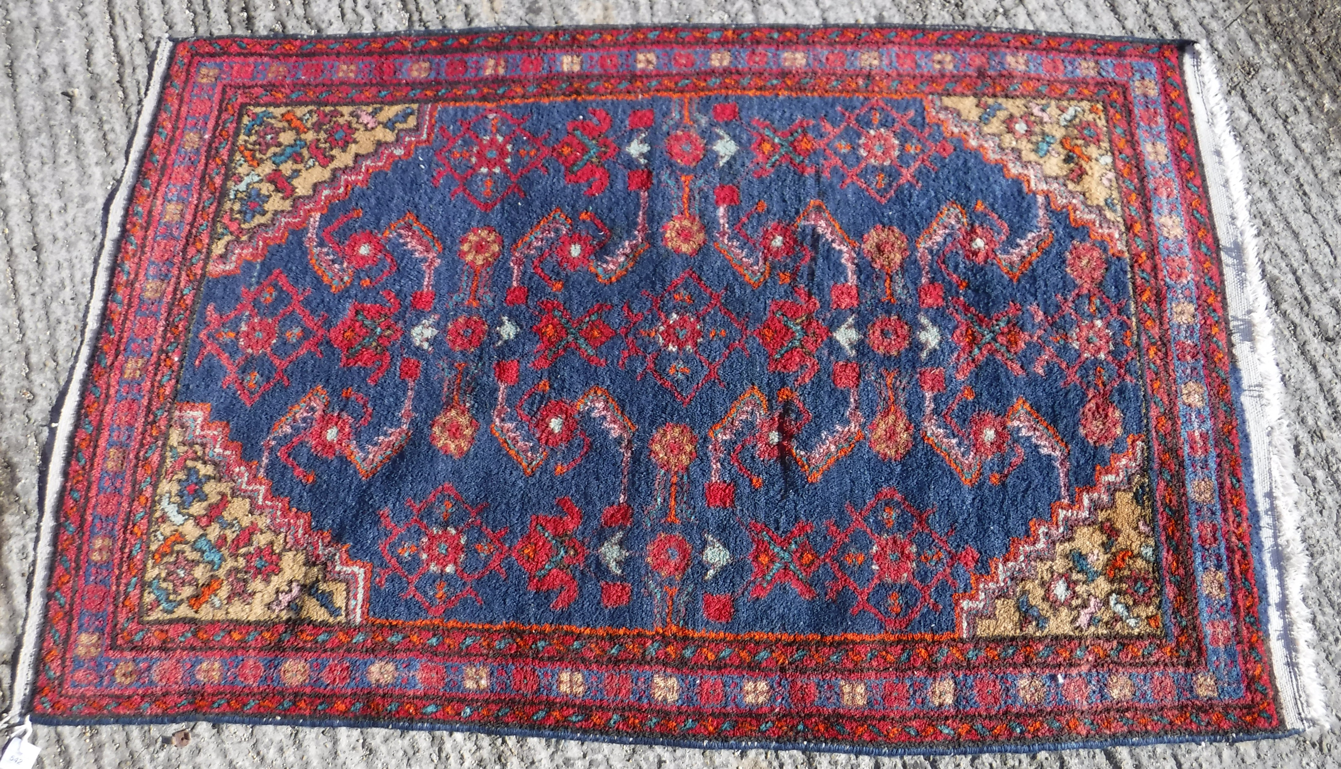 A Caucasian rug, the central panel set with stylised floral decoration on a blue ground, - Image 2 of 4