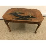 An early 20th Century walnut coffee table with chinoiserie decoration to top,