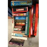 A box containing various board games including "Monopoly", "Chinese Chequers", "Sorry",