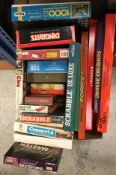 A box containing various board games including "Monopoly", "Chinese Chequers", "Sorry",