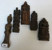 A collection of five ethnic carved wooden figures, three with plaited pony tails verso, tallest 24.