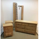 A modern oak chest of three short over four long drawers on stile supports,