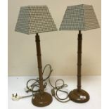 A pair of simulated bamboo table lamps on circular bases, with modern check shades,