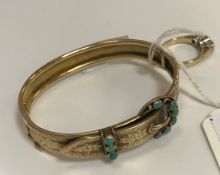 A Victorian yellow metal bangle in the form of a belt,