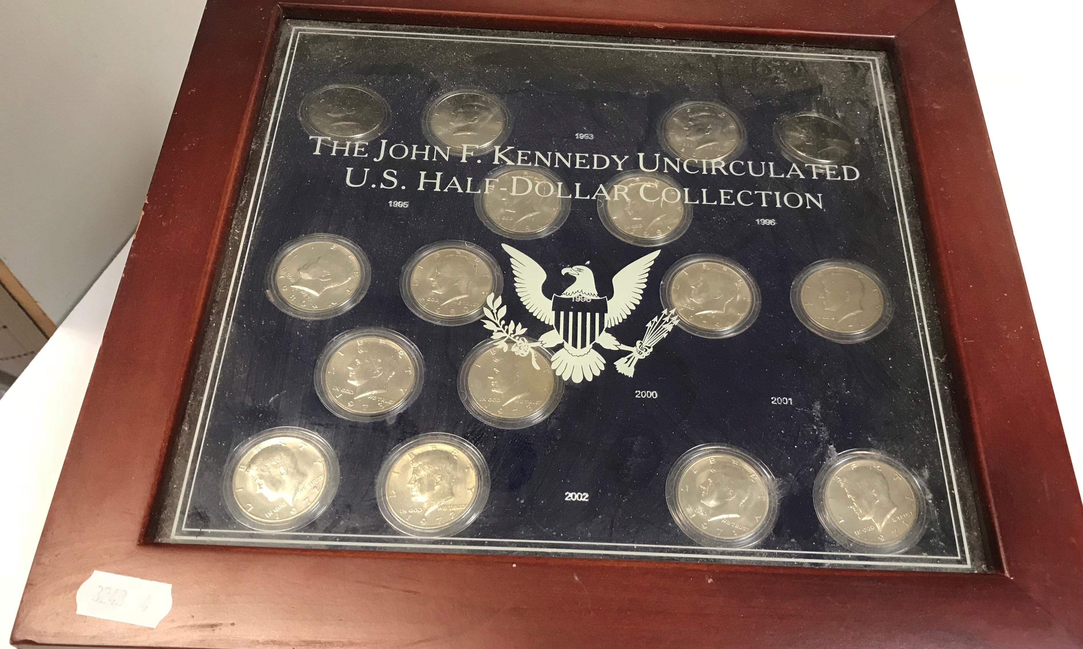 A "The John F Kennedy Uncircular US Half Dollar Collection Display Case" containing a part