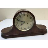 An early 20th Century mahogany cased mantel clock, the circular silvered dial with Arabic numerals,