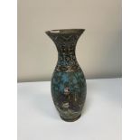 A Chinese cloisonne vase of baluster form with flared lip decorated with figures playing musical