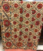 A 19th Century crewel work flower head decorated table cover or bedspread, approx double bed size,