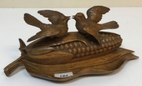 An early 20th Century Black Forest type desk stand as two birds upon a corn cob,