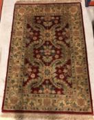 A Chobli rug, the central panel set with foliate decoration on a burgundy gorund,