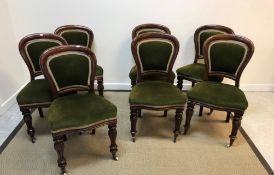 A harlequin set of seven Victorian spoon back dining chairs with green upholstered back rests and