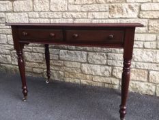 WITHDRAWN A Victorian mahogany washstand, the plain top above two drawers,