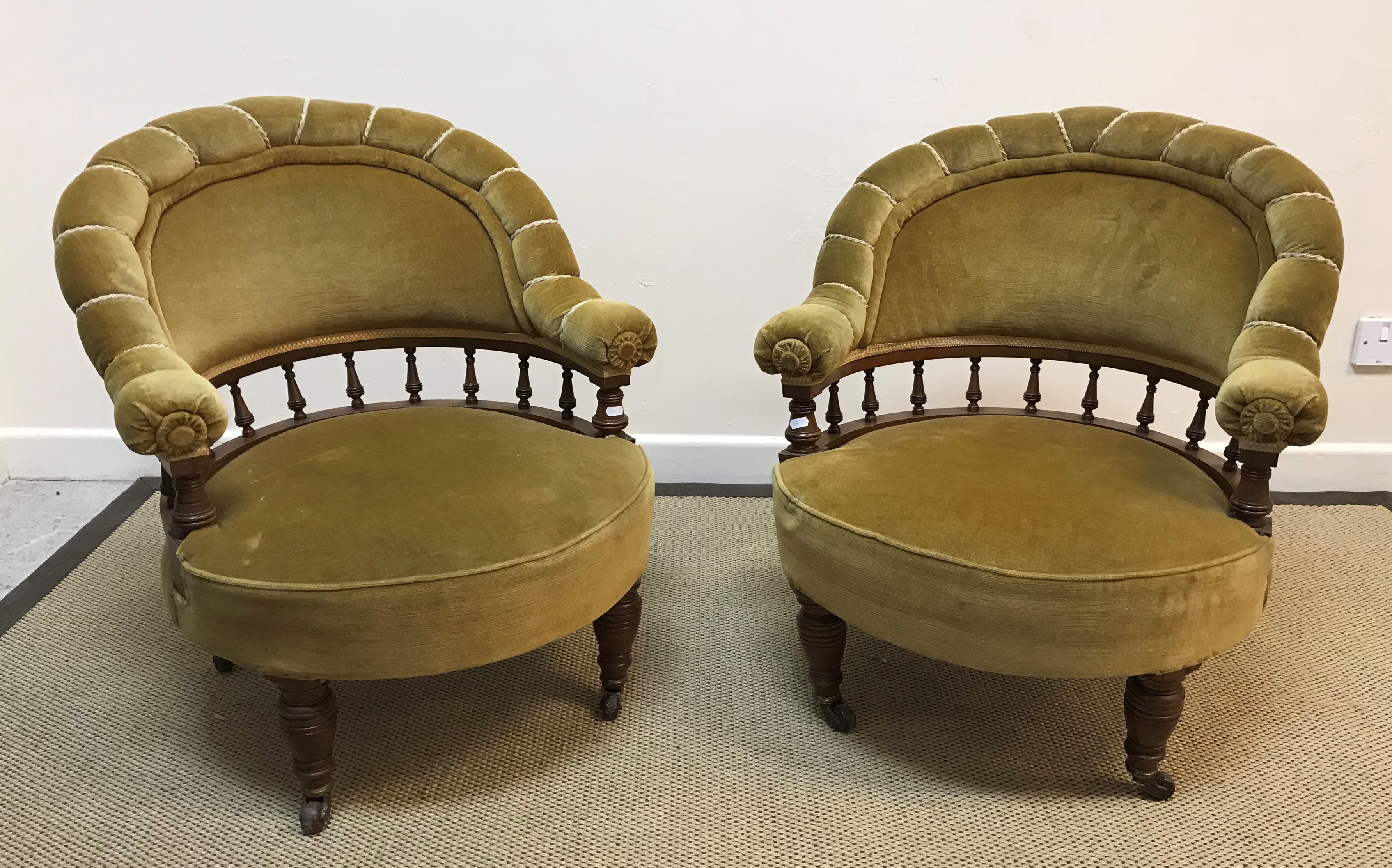 A pair of late Victorian walnut framed and gold velour upholstered low salon chairs,