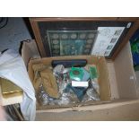 A box containing various stamps and coinage,