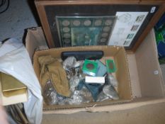 A box containing various stamps and coinage,