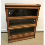 An oak three section Globe Wernicke bookcase of typical form,