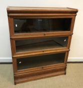 An oak three section Globe Wernicke bookcase of typical form,