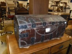 A 19th Century leather covered iron bound and brass studded trunk,