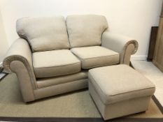 A modern Marks & Spencer two seat scroll arm sofa with fawn upholstery,