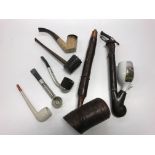 A collection of smoking requisites to include meerschaum pipe,