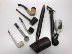 A collection of smoking requisites to include meerschaum pipe,