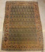 A Kashan rug, the central panel set with repeating hook motifs on a fawn and blue ground,