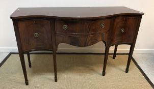 An Edwardian mahogany serpentine fronted sideboard in the George III taste,