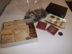 A box containing a collection British and World coinage