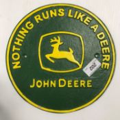 A modern painted cast iron sign inscribed "John Deere Nothing Runs Like a Deere",