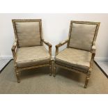 A pair of 19th Century gilt decorated elbow chairs in the Louis XV taste with upholstered backs,