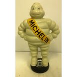 A modern painted cast metal Michelin man statue,