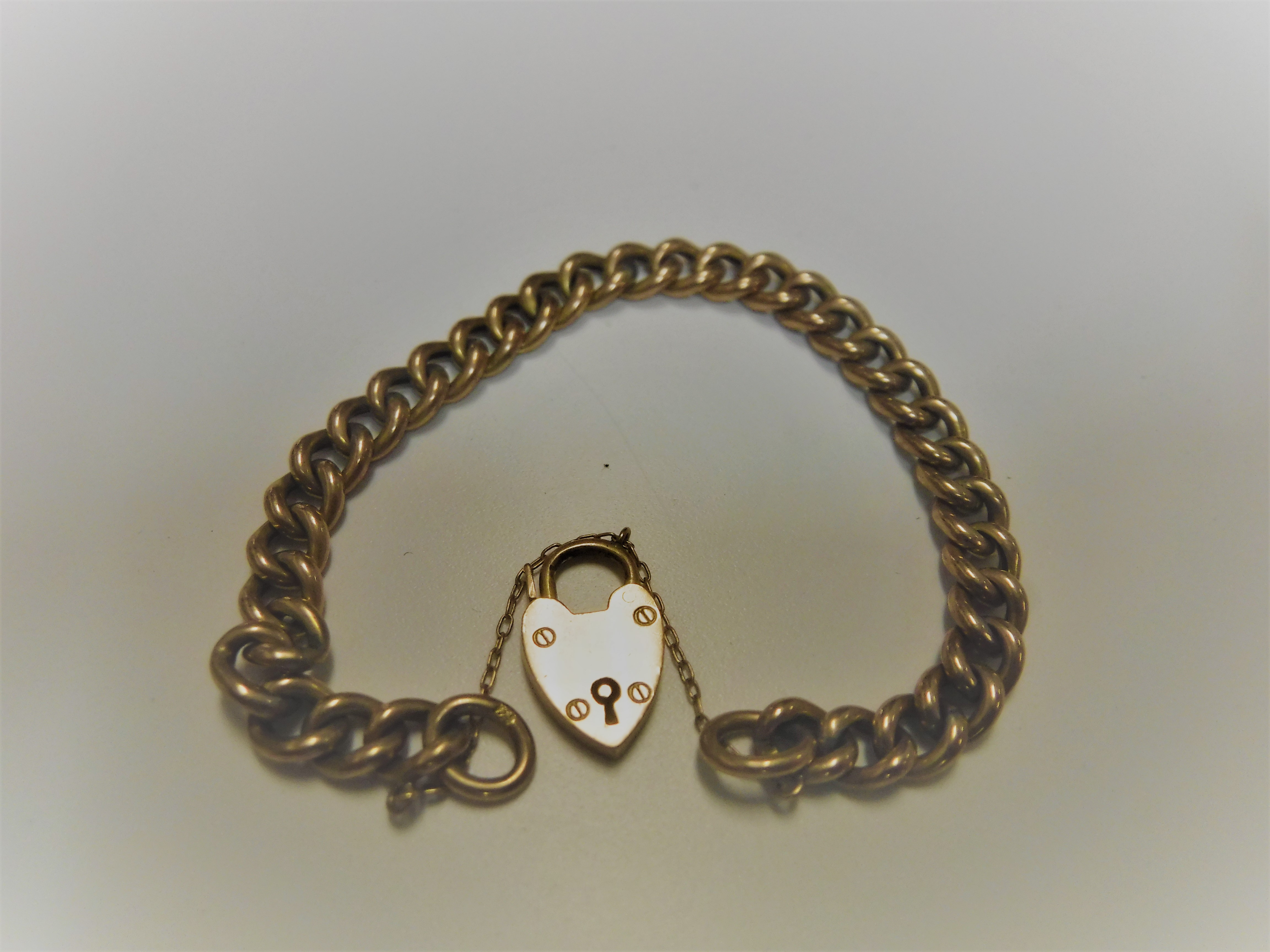 A 9-carat gold chain link bracelet with heart shaped lock, 12.