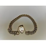 A 9-carat gold chain link bracelet with heart shaped lock, 12.