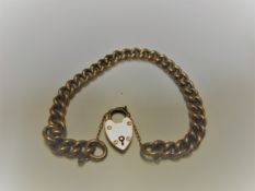 A 9-carat gold chain link bracelet with heart shaped lock, 12.