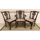 A set of nine modern Chippendale style carved dining chairs with drop-in seats on carved cabriole