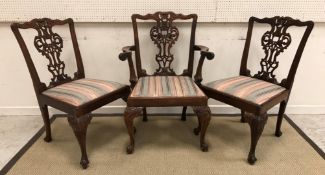 A set of nine modern Chippendale style carved dining chairs with drop-in seats on carved cabriole